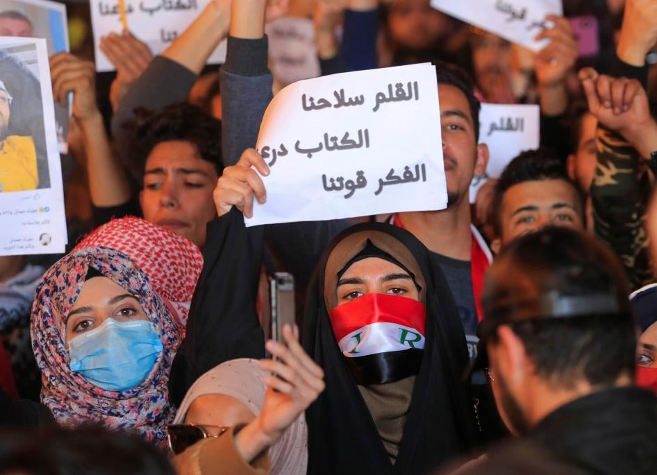 Woman holding up a sign in Arabic