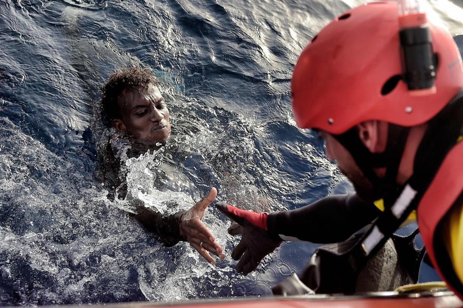 A man is rescued from the Mediterranean Sea by a member of Proactiva Open Arms NGO some 20 nautical miles north of Libya on October 3, 2016.  © 2016 Getty Images