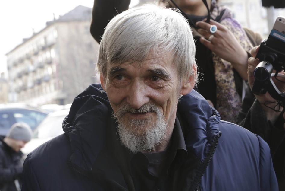 Historian Yuri Dmitriev, who was on trial on charges of involving his adopted daughter in child pornography, of illegally possessing components of a firearm, and of depravity involving a minor, speaks with people after a hearing outside a court building in Petrozavodsk, Russia. April 5, 2018.
