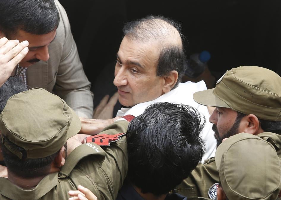 Pakistani police escort Mir Shakilur Rehman to court following his arrest in Lahore, Pakistan, March 13, 2020.