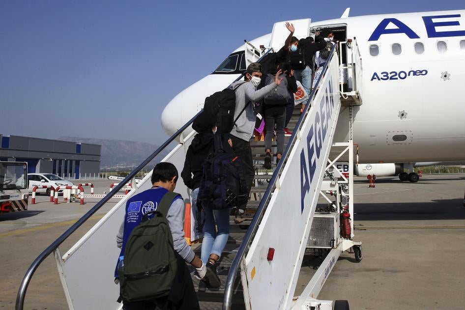 Unaccompanied children refugees from the overcrowded migrant camps on the north Aegean Sea islands, Greece, board a plane at the Eleftherios Venizelos International Airport in Athens to travel to Luxembourg, on Wednesday, April 15, 2020.