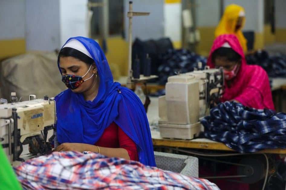 Workers sew clothes in a garments factory in Dhaka, Bangladesh, July 25, 2020.