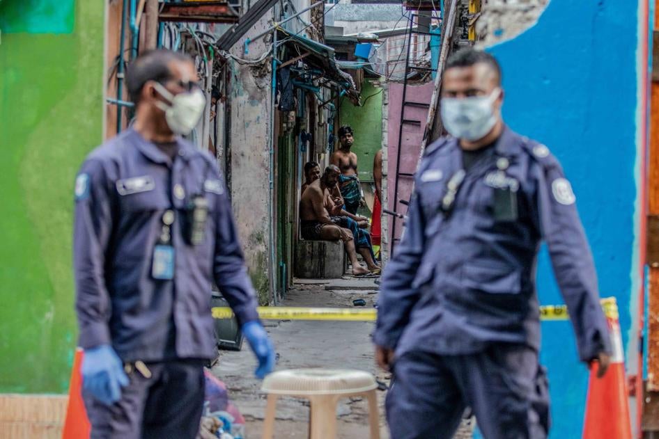 Security personnel patrol a migrant worker accommodation block under quarantine for Covid-19, Malé, Maldives, May 9, 2020.
