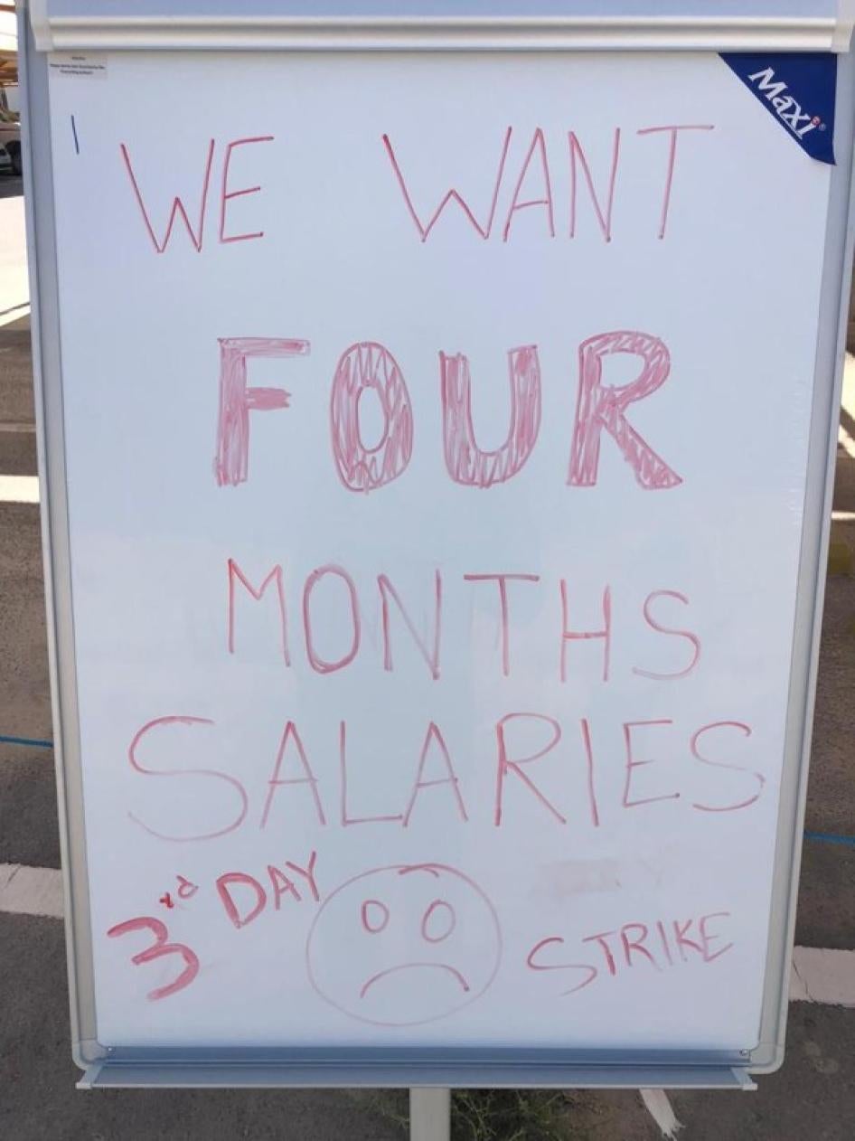 A sign that says, "We want four months salaries - 3rd day strike"