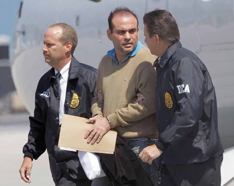 Colombian paramilitary warlord Salvatore Mancuso is escorted by US DEA agents on May 13, 2008 upon his arrival to Opa-locka, Florida.