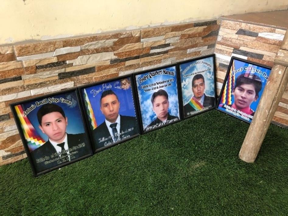 A row of framed photos of young men