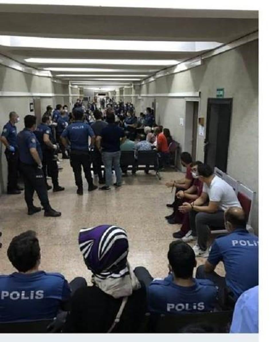 Defense lawyers, arrested in dawn raids on September 11 because they represent persons accused on terrorism charges, are handcuffed as they wait with police in the corridor of the Ankara courthouse, September 14, 2020 © 2020 private