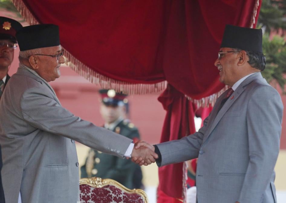 Nepal's Prime Minister Khadga Prasad Oli, left, shakes hand with former Maoist leader Pushpa Kamal Dahal, February 15, 2018. In May 2018, Oli and Dahal parties merged their parties to form the current ruling party, the Communist Party of Nepal. 