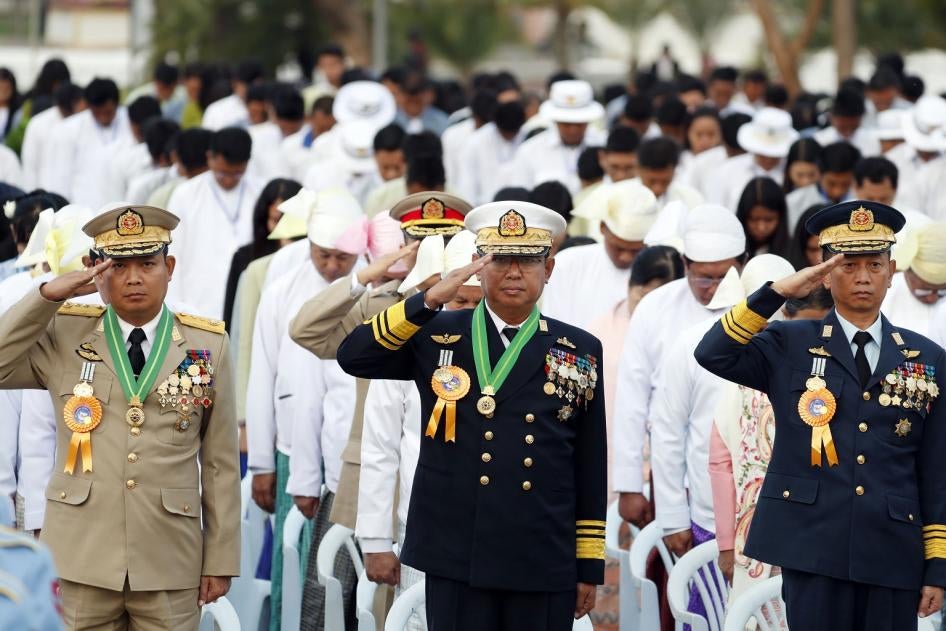 Myanmar military officers salute at their national flag during a ceremony to mark the 72nd anniversary of Independence Day in Naypyitaw, Myanmar. 