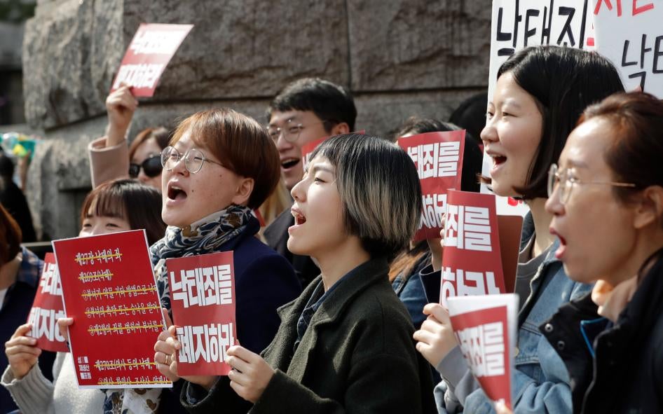 Protesters celebrate after listening to a judgment during a rally demanding the abolition of abortion law outside of the Constitutional Court in Seoul, South Korea, April 11, 2019.