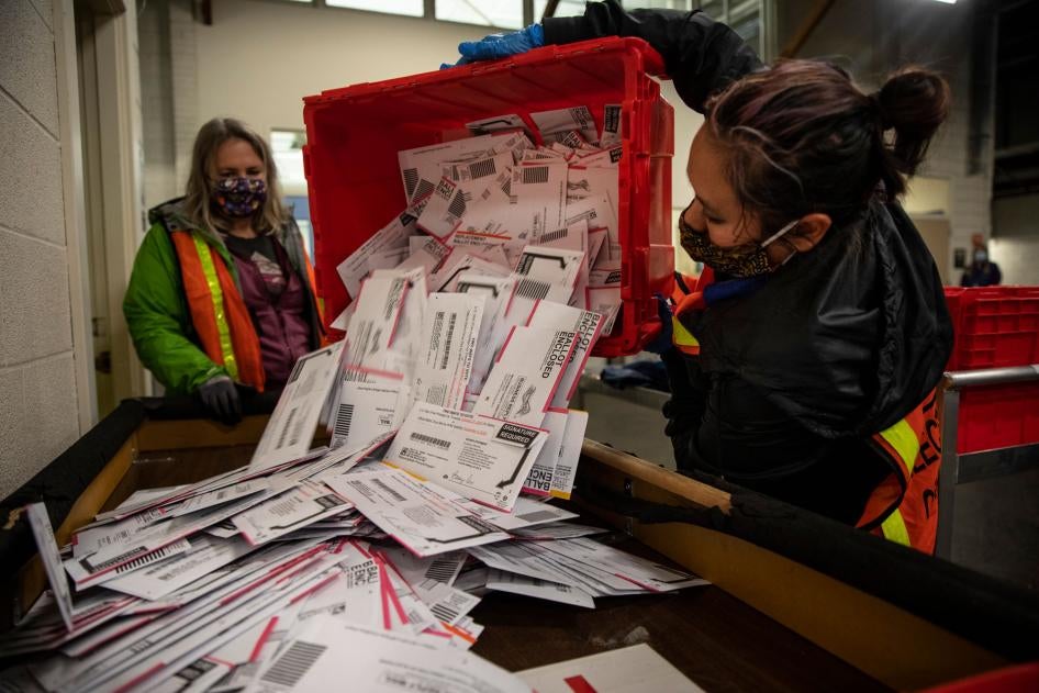 Election workers empty ballots at the Multnomah County Elections Division in Portland, Oregon, November 3, 2020. 