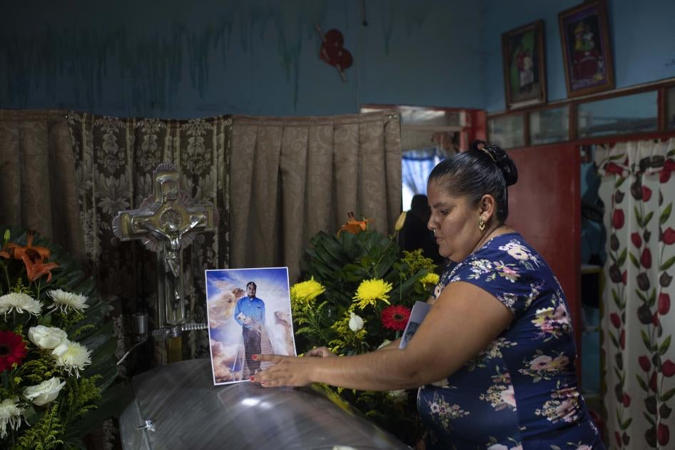 A woman places a photo of slain journalist Julio Valdivia on his casket during a wake inside his home in Tezonapa, Mexico, on September 10, 2020.