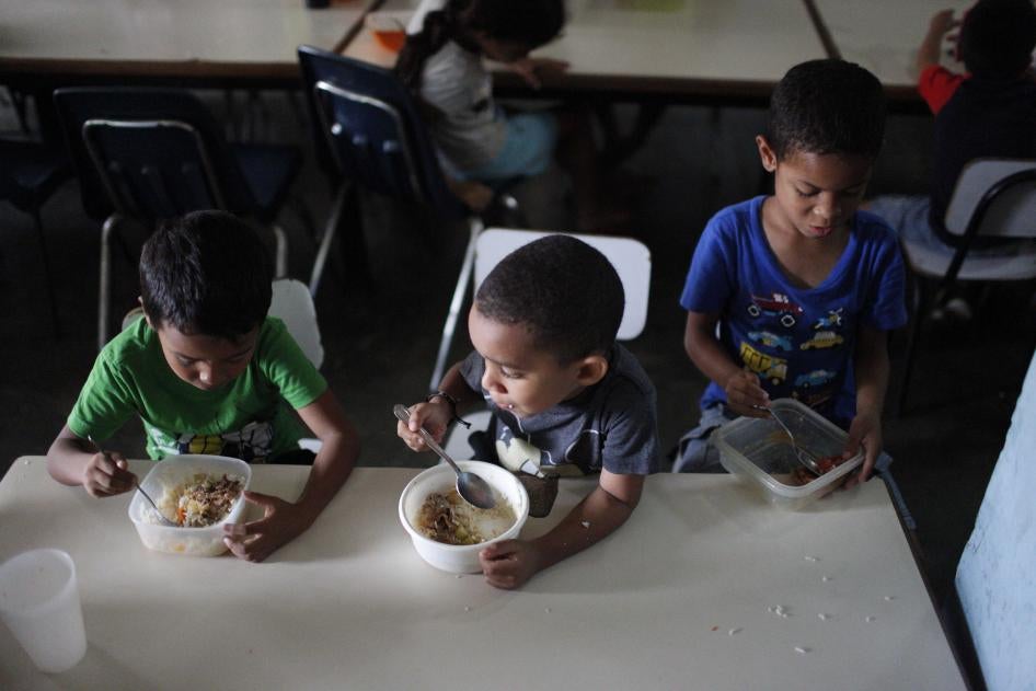 Children eat lunch at Madre Asunción's community kitchen, which is ran by the NGO Alimenta La Solidaridad, on October 9, 2019 in Petare, Caracas, Venezuela.