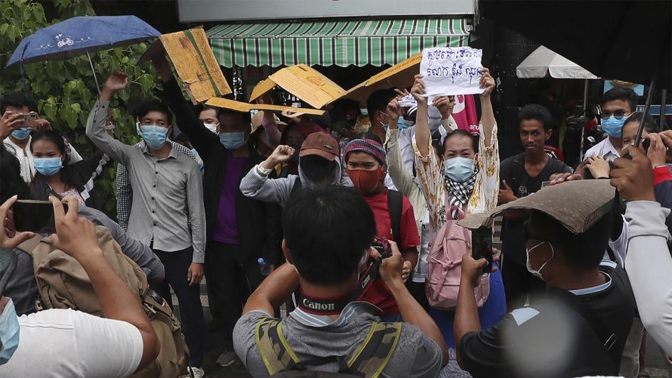 Supporters of Rong Chhun, president of the Cambodian Confederation of Unions, shout slogans in front of Phnom Penh Municipal Court in Phnom Penh, Cambodia on Saturday, August 1, 2020. 