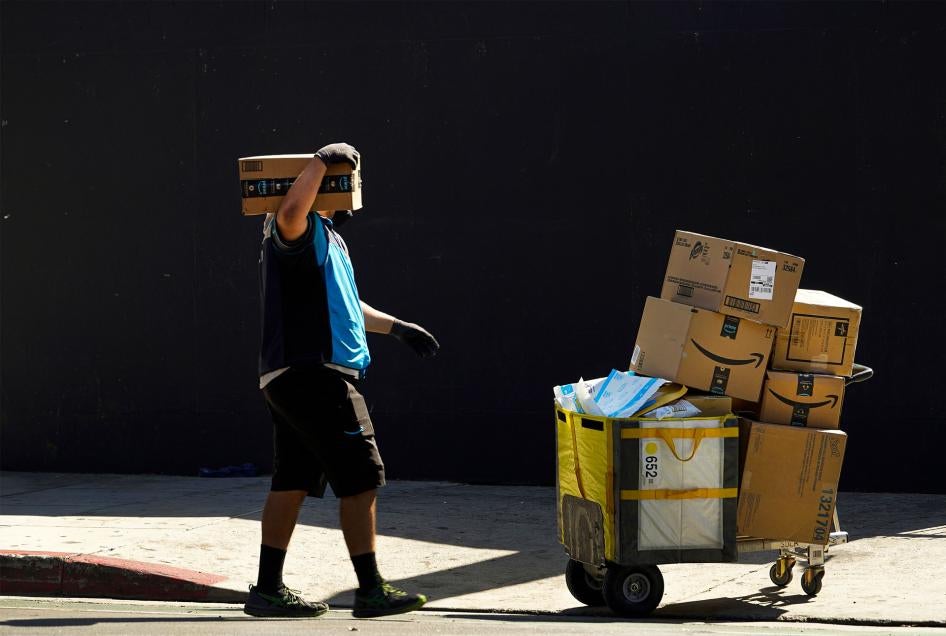 An Amazon worker delivers boxes in downtown Los Angeles, California, October 1, 2020. 