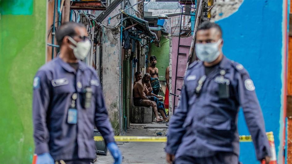 Security personnel patrol an accommodation block where Bangladeshi migrant workers are being quarantined after Covid-19 cases were found in the area, Malé, Maldives, May 9, 2020.