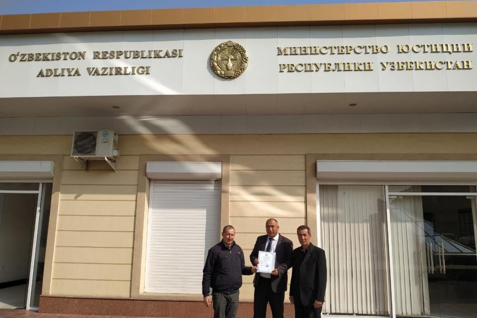 Azam Farmonov, center, and Dilmurod Saidov, right, after receiving a registration certificate for their NGO “Huquqi Tayanch“ in front of the Justice Ministry in Tashkent, Uzbekistan.