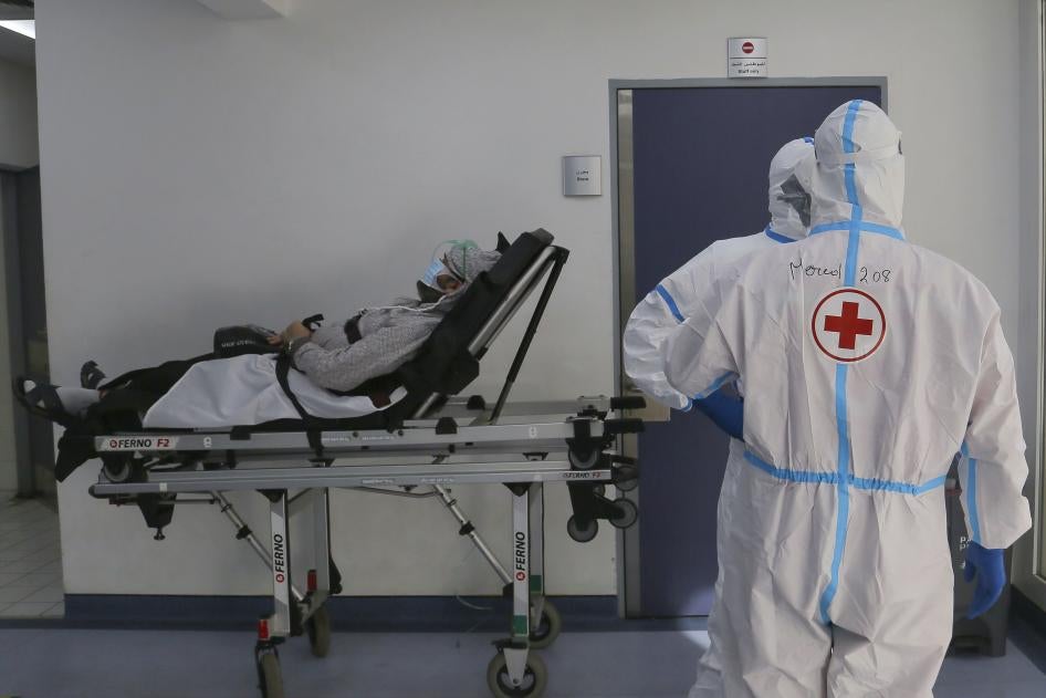 Red Cross volunteers waiting with a coronavirus patient for a place in the intensive care unit of Rafic Hariri University Hospital, Beirut, January 11, 2021.