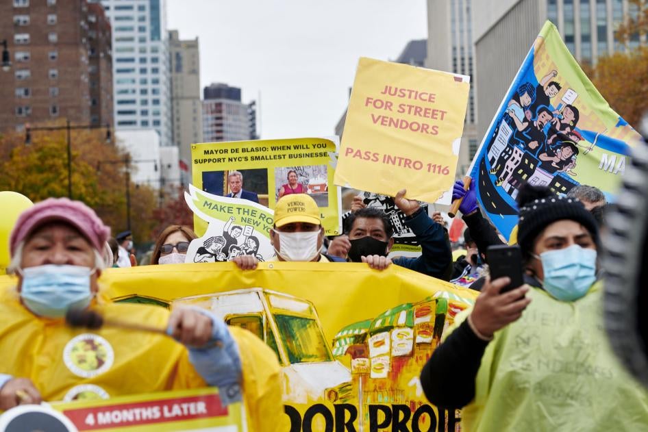 Street vendors and supporters march across Brooklyn Bridge during a rally in the Brooklyn borough of New York City, November 12, 2020.