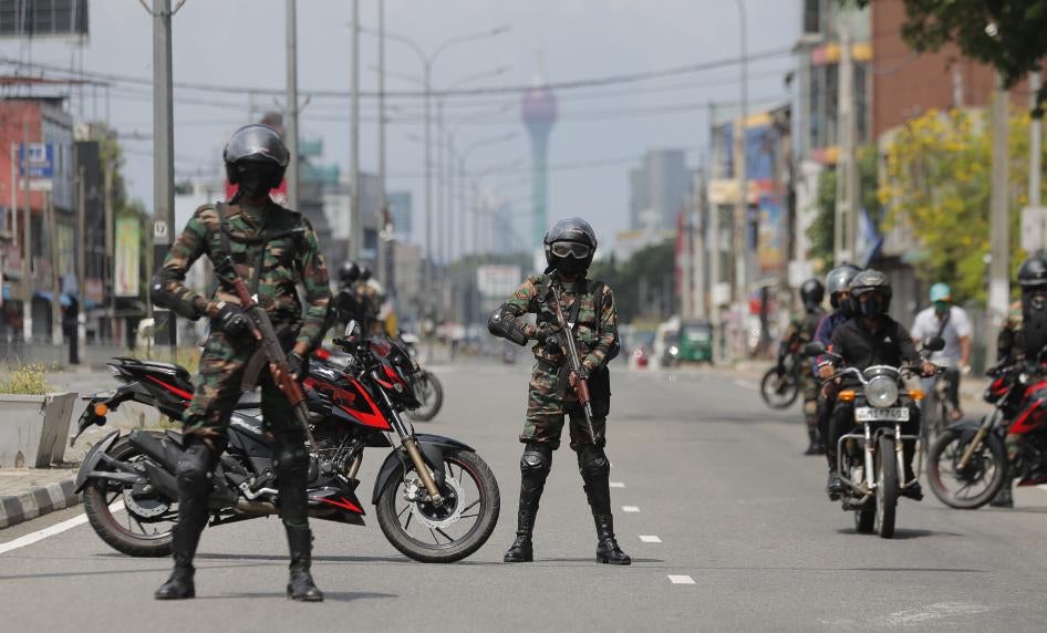 Armed soldiers guard a street