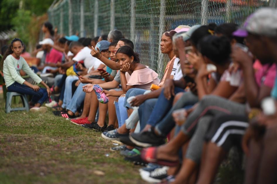 Relatives and friends of Venezuelan migrants who died when a boat transporting them to Trinidad and Tobago sank, wait for news of the recovery of their bodies, in Güiria, Venezuela, on December 18, 2020.