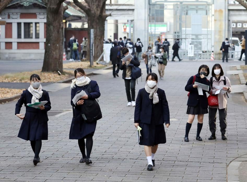 High school students wearing face masks walk in Tokyo, January 16, 2021. 