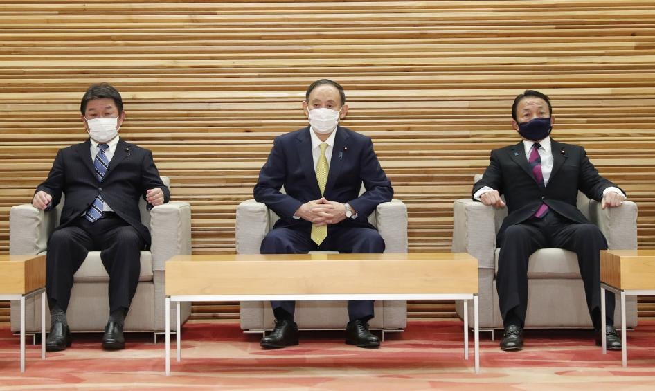 Japanese Foreign Minister Toshimitsu Motegi (left), Prime Minister Yoshihide Suga (center), and Finance Minister Taro Aso (right) attend a Cabinet meeting in Tokyo on February 24, 2021.