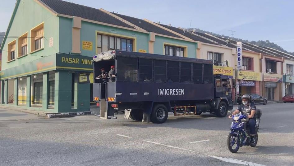 Image taken from a video of an immigration truck with security guards and unidentified people on the road to Lumut Naval Base on Tuesday, February 23, 2021 in Lumut, Malaysia. 