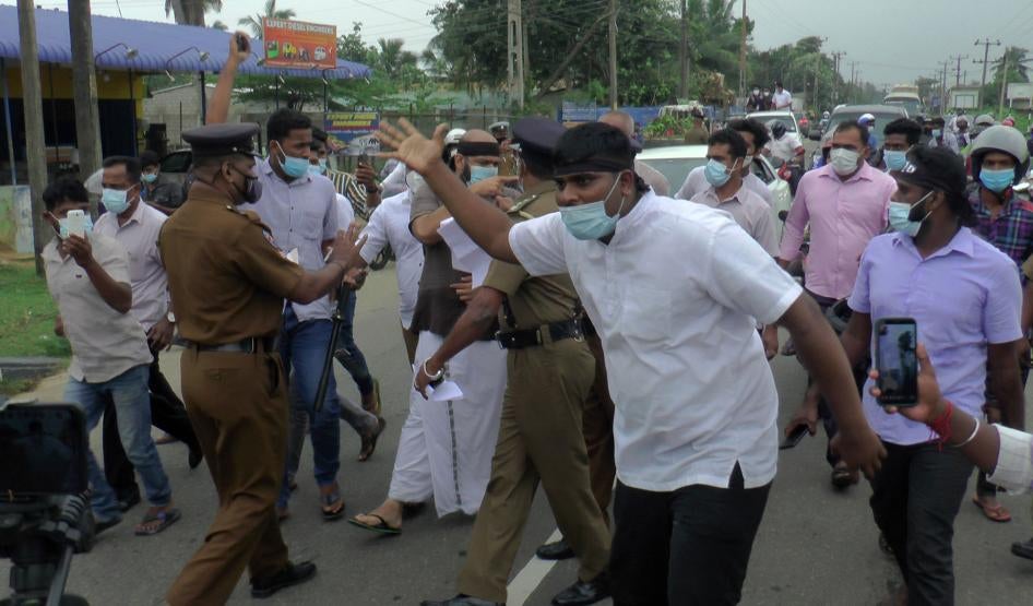 Police try to stop supporters of Sri Lanka's Tamil National Alliance marching in Addalaichenai, Sri Lanka, February 3, 2021.
