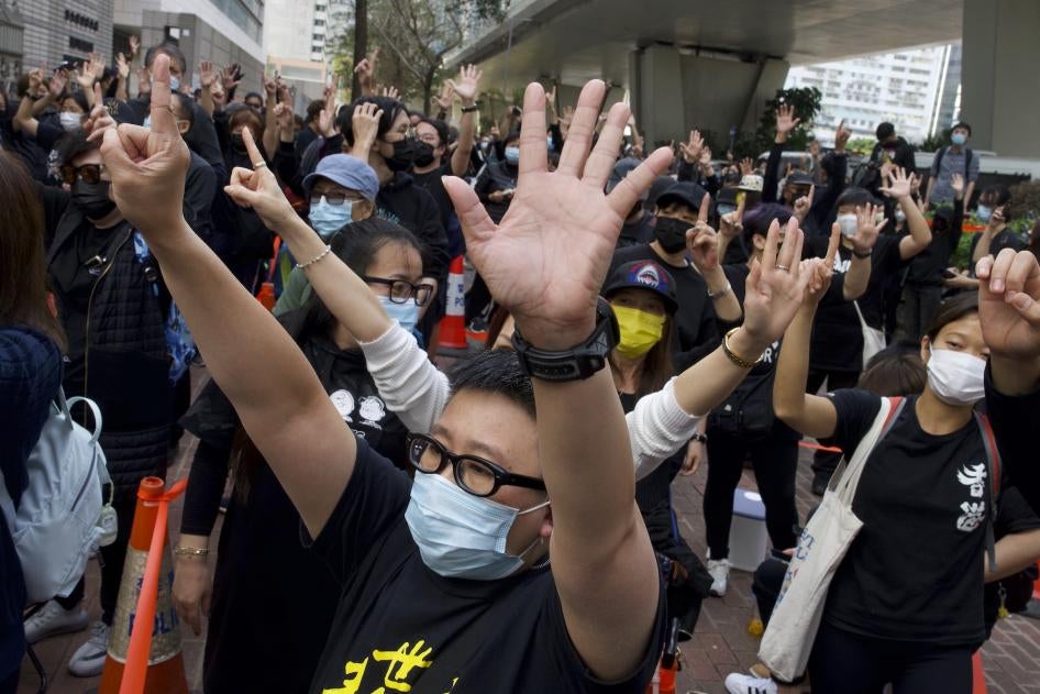 Supporters protest outside a court in Hong Kong where police brought 47 pro-democracy activists, March 1, 2021.