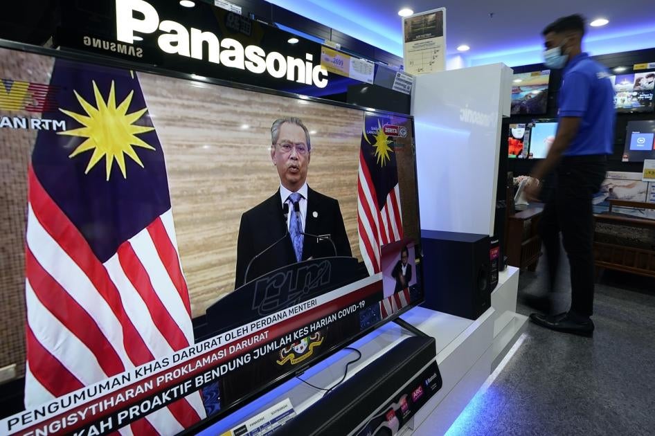 A television shows a live broadcast of Malaysian Prime Minister Muhyiddin Yassin at a shopping outlet in Kuala Lumpur, Malaysia, Tuesday, Jan. 12, 2021. 