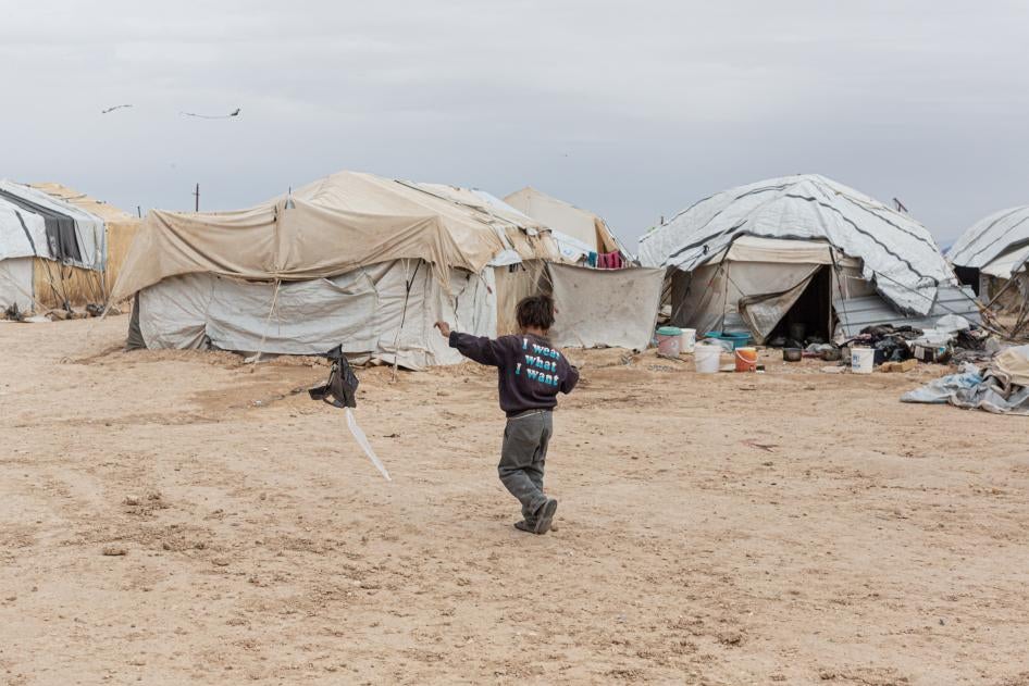 A boy flies a home-made kite in the foreigners’ section of al-Hol camp in northeast Syria on March 15, 2021.