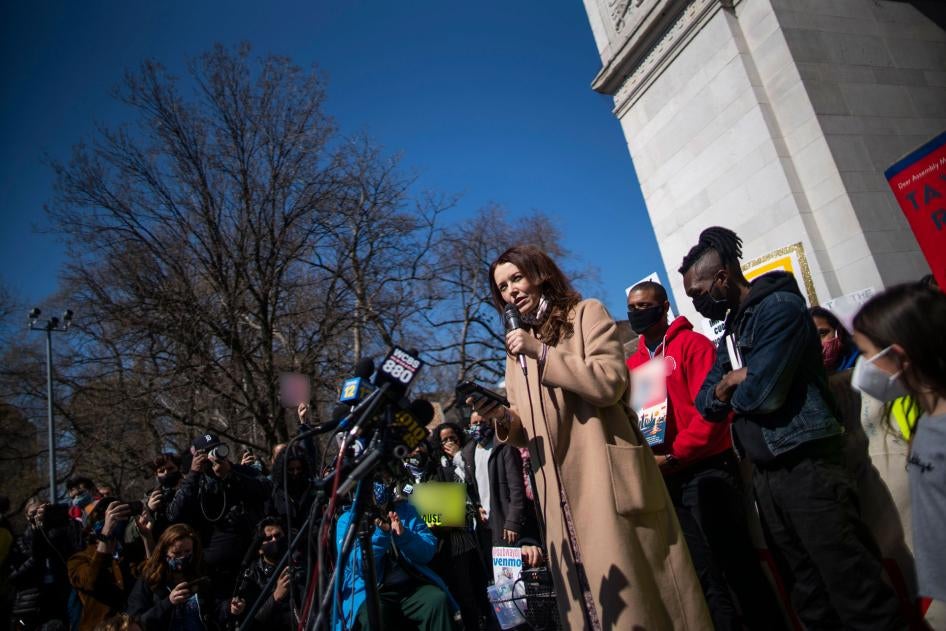 Lindsey Boylan, a former state economic development adviser for New York Governor Andrew Cuomo, speaks in front of microphones and a crowd of people holding signs at a rally in New York City, March 20, 2021. 