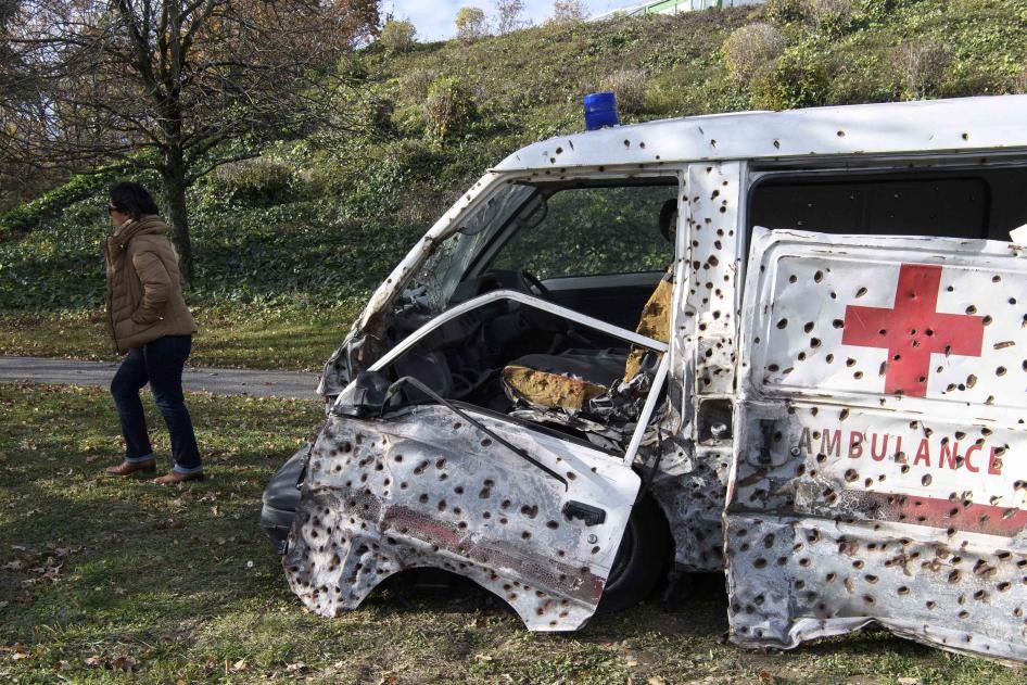 An ambulance covered in bullet holes 