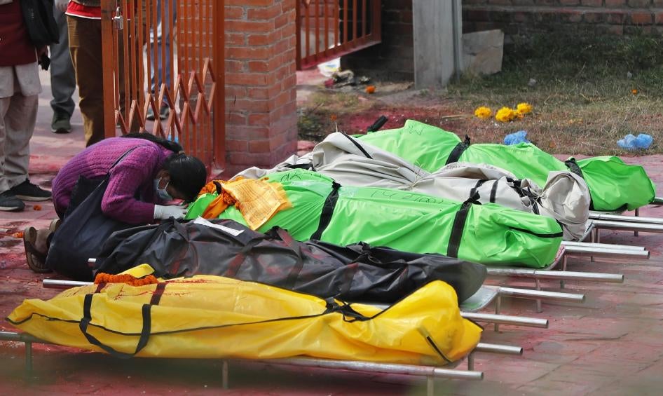 A family member mourns next to the bodies of COVID-19 victims at a crematorium near Pashupatinath temple in Kathmandu, Nepal, May 7, 2021. (AP Photo/Niranjan Shrestha)