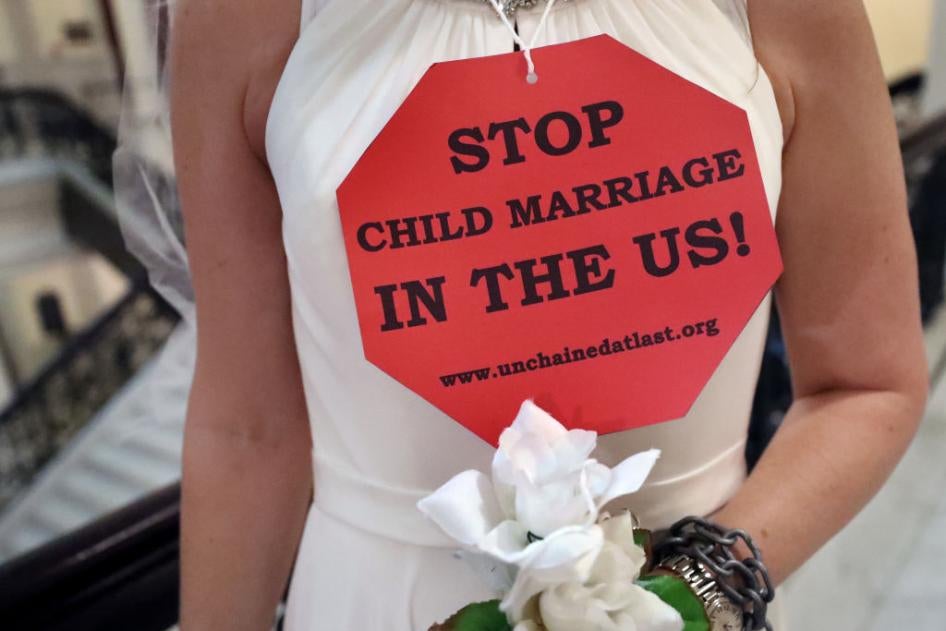 A demonstrator wearing a bridal gown takes part in a protest urging legislators to end Massachusetts child marriage