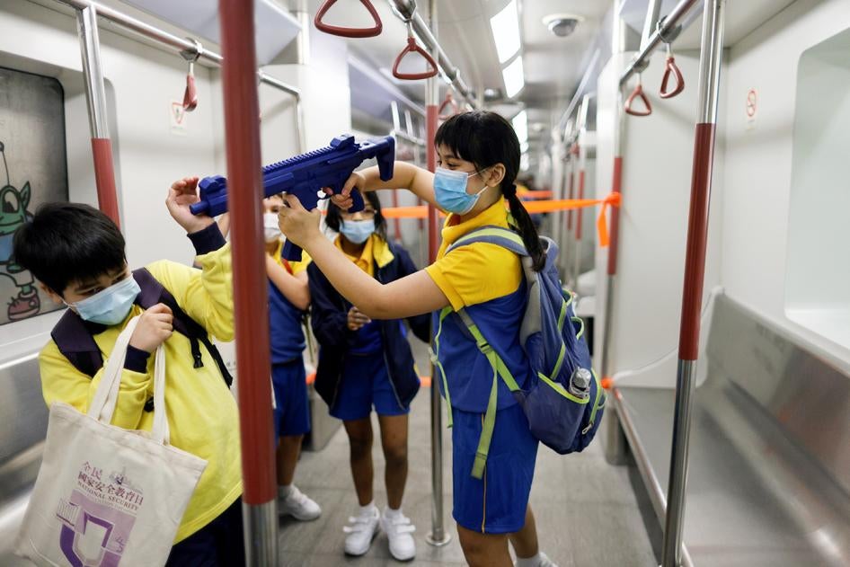 During Hong Kong’s first “National Security Education Day,” a child is given a mock submachine gun to play with at a model Mass Transit Railway (MTR) station at Hong Kong Police College, on April 15, 2021.