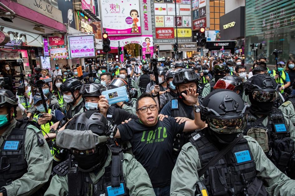 Tam Tak-chi, also known as Fast Beat, is arrested by the police on May 24, 2020, while handing out masks and criticizing the government at a street stall.  