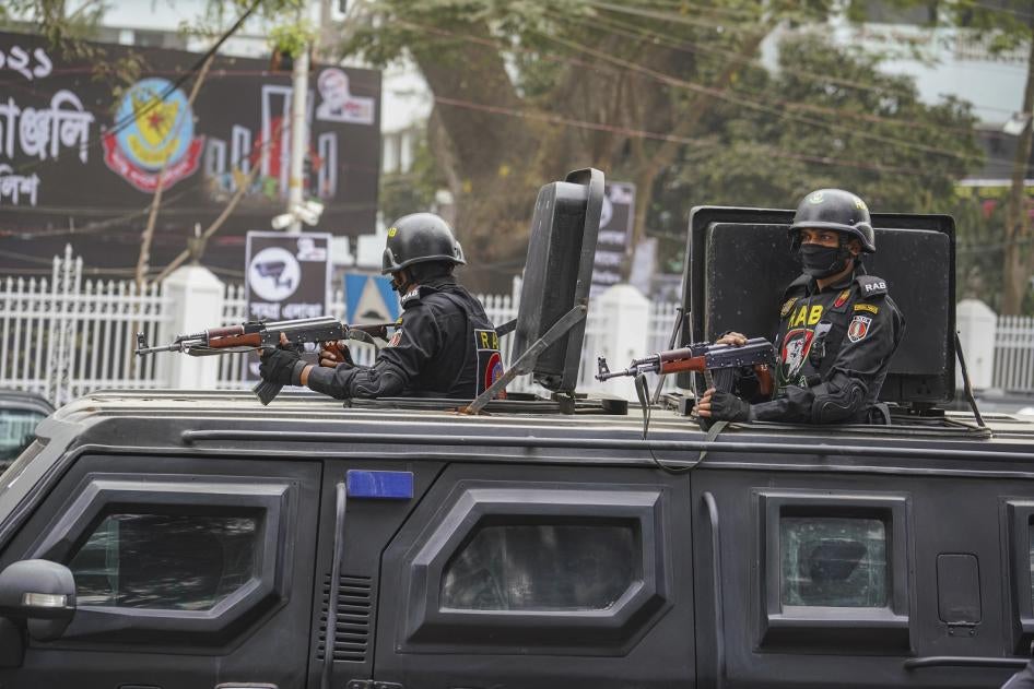 Rapid Action Battalion (RAB) officials stand alert inside a truck in front of Central Shaheed Minar in Dhaka, Bangladesh on February 20, 2021.