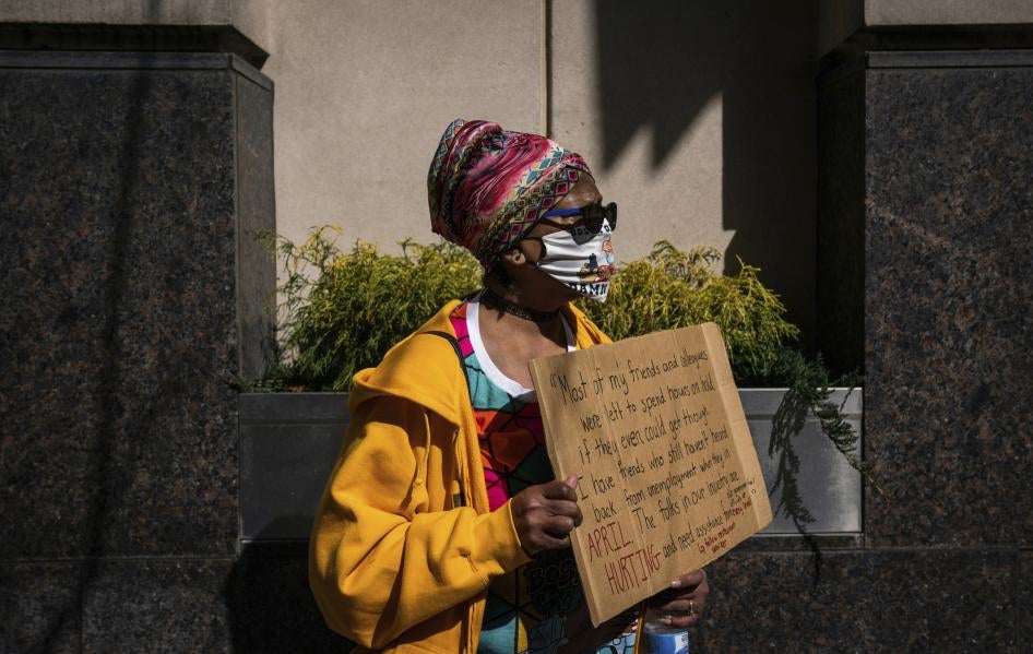Gina Stanton, of the Homewood neighborhood in Pittsburgh, Pennsylvania, attends a rally held by the Mon Valley  Unemployed Committee and Pittsburgh Restaurant Workers Aid Group at Governor Tom Wolf’s regional office on March 10, 2021, downtown Pittsburgh.