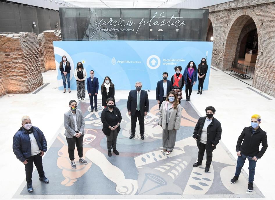 President Alberto Fernández (center) with other authorities and members of social organizations, form an 'X', at the Bicentennial Museum in Casa Rosada, Buenos Aires, Argentina, on July 21, 2021