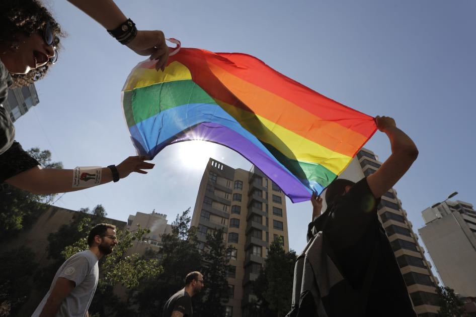 LGBT activists in Beirut, Lebanon shout slogans and hold up a rainbow flag as they march to demand equal rights in a country gripped by economic and financial crisis, June 27, 2020.