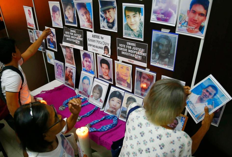 Families of victims of alleged extrajudicial killings in the so-called "war on drugs" with portraits of their slain relatives on July 9, 2019, in Manila, Philippines.
