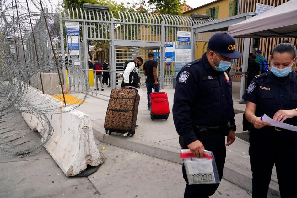 Honduran men cross into the United States to begin the asylum process Monday, July 5, 2021, in Tijuana, Mexico. The administration of President Joe Biden continues to turn away thousands of asylum seekers under the illegal and discriminatory Title 42 summary expulsion policy.