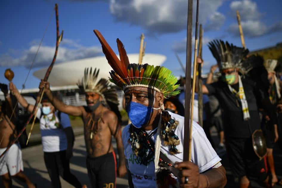 Indigenous people protest against a bill on the demarcation of indigenous land, on the roof of the National Congress, on June 8 2021, in Brasilia, Brazil. Photo: Mateus Bonomi/AGIF (via AP)
