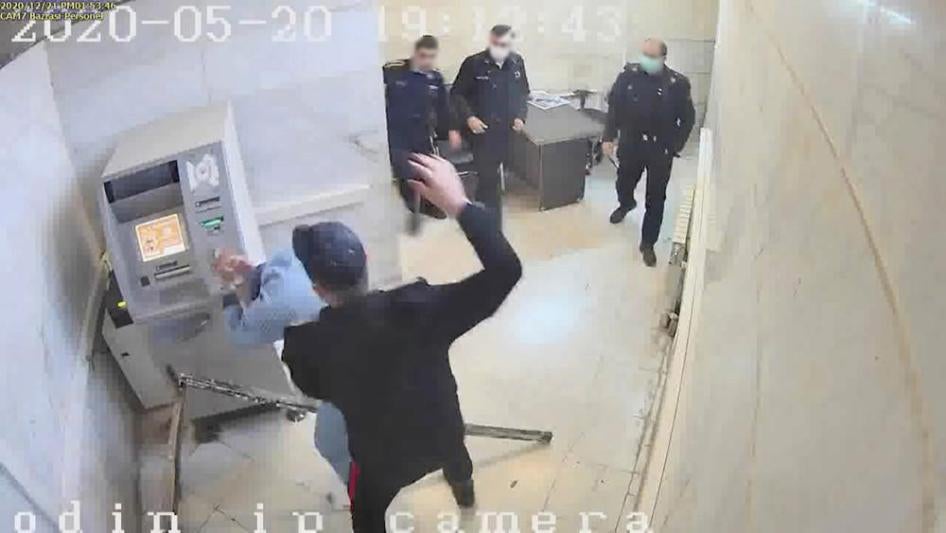 In this undated frame grab taken from video shared with The Associated Press by a self-identified hacker group called "The Justice of Ali," a guard hits a prisoner, at Evin prison in Tehran, Iran. 