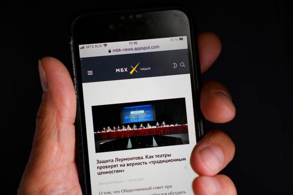 A smart phone user reads MBKh Media news site, one of three news outlets whose websites were blocked on August 4, 2021.