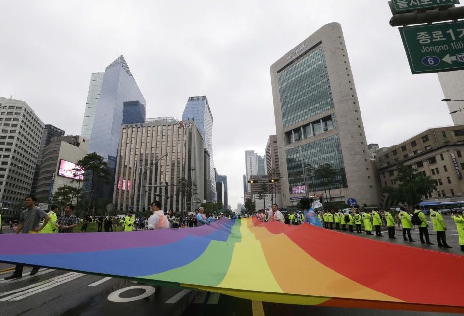 Participants march with a rainbow flag during a gay pride parade in Seoul, South Korea.