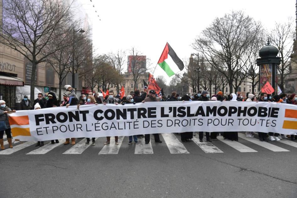 Protesters hold a banner at a demonstration against a bill dubbed as "anti-separatism" and islamophobic in Paris, France on March 21, 2021.