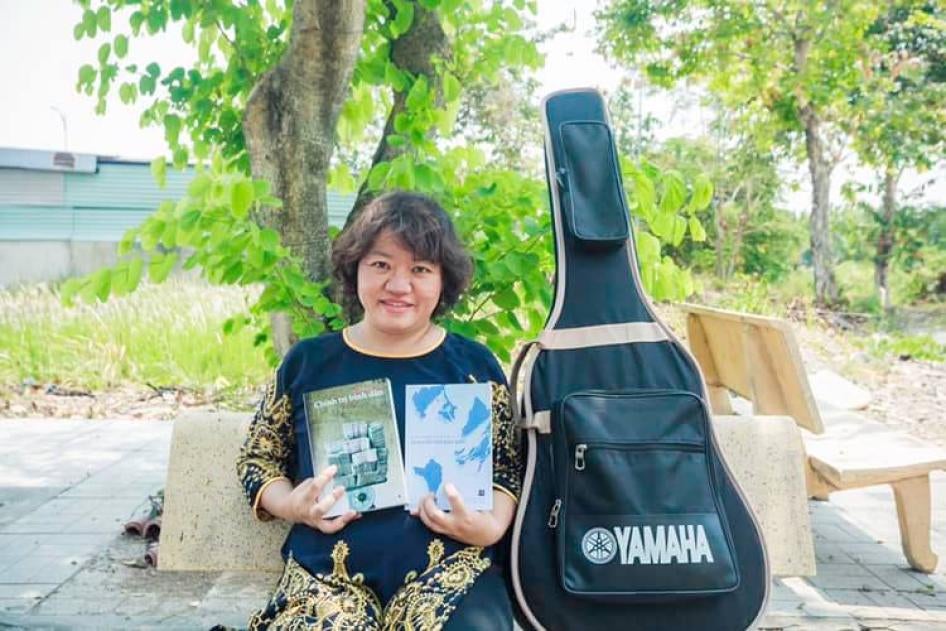 Pham Doan Trang with two books that she co-authored, 2019.